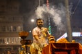 Portrait of hindu male priest performing ganga aarti in varanasi