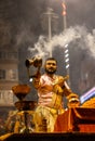 Portrait of hindu male priest performing ganga aarti in varanasi