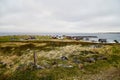 Varde, Norway - June 23, 2019: Calm landscape with water and fishing village on the bank of a beautiful fjord in a morning, Norway