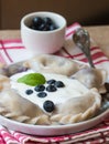 Vareniki. Dumplings with blueberries. Served with sour cream