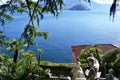 View to ancient sculptures of the Villa Monastero garden in Varenna, to the lake Como and Bellagio peninsula.