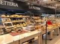 Bakery department with fresh bread on shelves inside of the IPER of Varese hypermarket, Italy