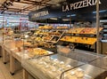 Bakery department with fresh bread on shelves inside of the IPER of Varese hypermarket, Italy