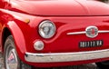 The front of the Red Classic Vintage Italian Fiat 500, parked in the historic center of Varese, Italy