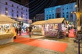 People in the evening among the stalls of a Christmas market looking for gifts Royalty Free Stock Photo