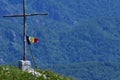 Varful Buila Vantura, Romania - 09 05 2019: Romanian flag waving on top of the Parang mountain at sunset. drapel in three colors. Royalty Free Stock Photo