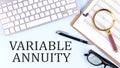 VARIABLE ANNUITY text on blue background with keyboard and clipboard, business concept Royalty Free Stock Photo