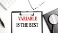 VARIABLE IS THE BEST text written on paper clipboard with office tools Royalty Free Stock Photo