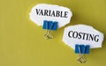 VARIABLE COSTING - the words is printed on a white piece of paper on a yellow background
