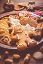 Variation of Christmas cookies, gingerbread man and nuts with candle and ornaments Royalty Free Stock Photo