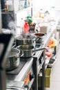 Dishes boiling in sauce pans at restaurant kitchen