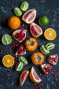 Variation of fresh fruit - grapefruit, persimmon, kiwi, pomegranate, orange, lime. On the tena background