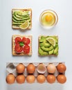 Variation of healthy breakfast toasts with avocado and cherry tomatoes on white background.