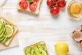 Variation of healthy breakfast toasts with avocado and cherry tomatoes