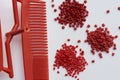 Different red plastic resins with processed comb Royalty Free Stock Photo