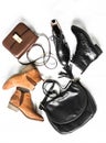 Variation of women`s shoes and bags. Suede chelsea, cross body bag, classic black leather shoes and black bag on a light Royalty Free Stock Photo