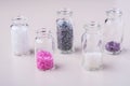 Varied colors beads in transparent bottles white background