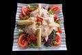Varied Vegetable Salad topped by an olive isolated
