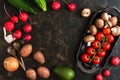 Varied vegetables and mushrooms on a rustic ceramic dish. Dark brown background, top view, empty center for text. Royalty Free Stock Photo