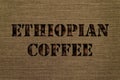 Varieties of Ethiopian coffee text made up of coffee beans on a background of canvas fabric