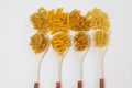 Varieties of pasta spilling out of spoons Royalty Free Stock Photo