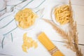 varieties of pasta on a white wooden table, spaghetti, Penne, maltagliati, local cuisine