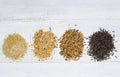 Varieties of Rice in piles on top of White Wood Royalty Free Stock Photo