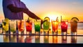 Variety of alcoholic cocktails on a bar counter at sunset or sunrise Royalty Free Stock Photo