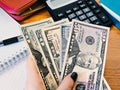 Variety of American money laid out under a stack of cash.Hundred US dollar bills. Selective focus. Royalty Free Stock Photo