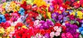 A variety of artificial flowers. Colorful background of flowers.