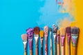 A variety of artist paint brushes laid out on a vibrant background, in art class extracurricular hobby at school or