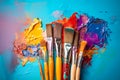 A variety of artist paint brushes laid out on a vibrant background, in art class extracurricular hobby at school or