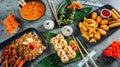 many dishes in trays with asian and thai food on them