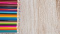 Colorful colored pencils arranged on a wooden table Royalty Free Stock Photo