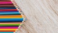 Colorful colored pencils arranged on a wooden table Royalty Free Stock Photo