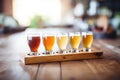 variety of beer flights on a wooden table