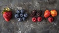 A variety of berries on a slate background. AIG51A Royalty Free Stock Photo