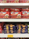 Variety of biscuits in good and interesting packaging and displayed on the racks inside the shop.