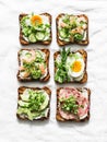 Variety breakfast, appetizer, tapas bread sandwiches with cream cheese, egg, asparagus, avocado, cucumber, shrimp, salami, micro
