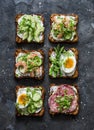 Variety breakfast, appetizer, tapas whole grain bread sandwiches with cream cheese, egg, asparagus, avocado, cucumber, shrimp,