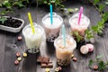 Variety of bubble tea in plastic cups with straws on a wooden ta Royalty Free Stock Photo