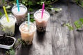 Variety of bubble tea in plastic cups with straws on a wooden ta Royalty Free Stock Photo