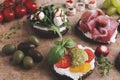 Variety of canape with salmon, prosciutto,avocado, mozzarella ,tomato,pesto,olives, cream cheese. Mix of different snacks and appe Royalty Free Stock Photo