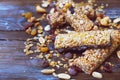 Variety of cereal bars with nuts, seeds, dried fruits and chocolate on the wooden table,top view. Royalty Free Stock Photo