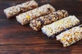 Variety of cereal bars with nuts, seeds, dried fruits and chocolate on the wooden table,top view. Royalty Free Stock Photo