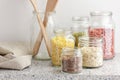 Variety of cereals, grains, pasta, seeds in glass jars uncooked on white kitchen background, closeup, zero waste, eco friendly Royalty Free Stock Photo