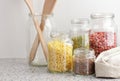 Variety of cereals, grains, pasta, seeds in glass jars uncooked on white kitchen background, closeup, zero waste, eco friendly Royalty Free Stock Photo