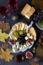 Variety of cheese and fruits on gray table. Appetizer for Thanksgiving Day. Flat lay