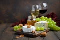 Variety of cheese with grapes, walnuts and wine. Royalty Free Stock Photo