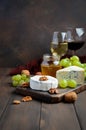 Variety of cheese with grapes, walnuts and wine. Royalty Free Stock Photo